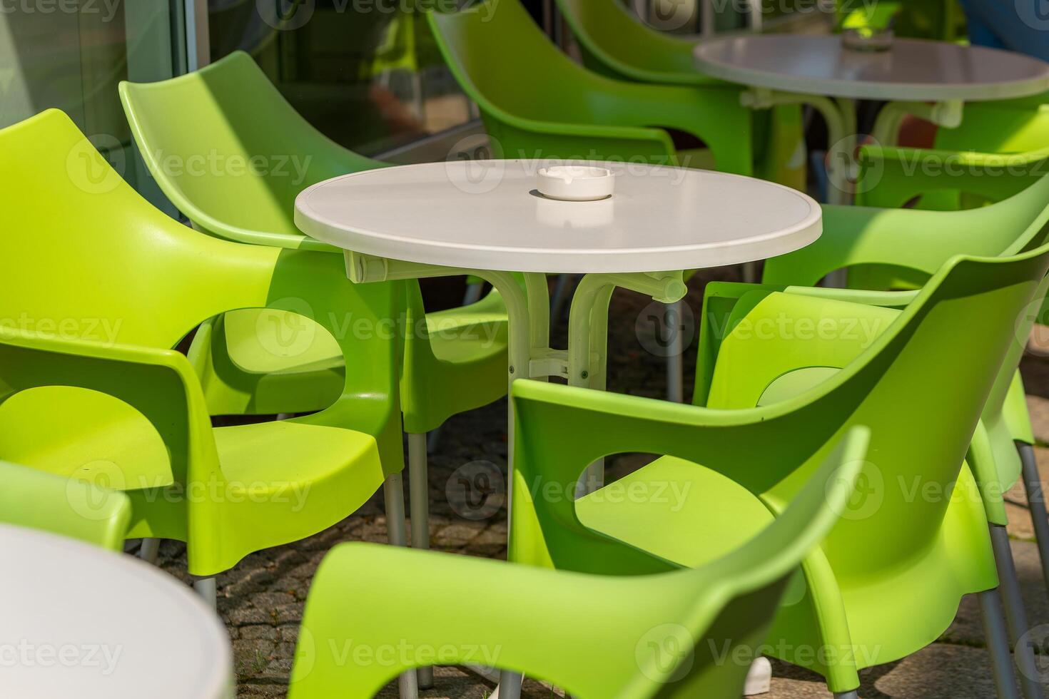 green table with a white tablecloth and a ashtray on it photo