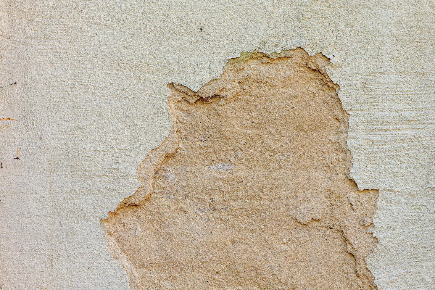 wall with a hole in it and a patch of cement photo