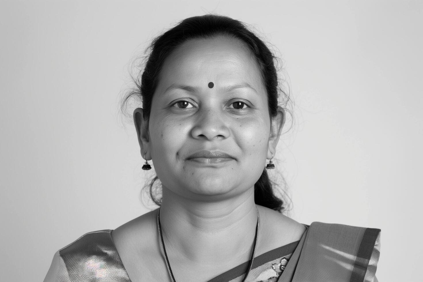 Black and White Portrait of an Indian Woman Wearing a Sari. photo