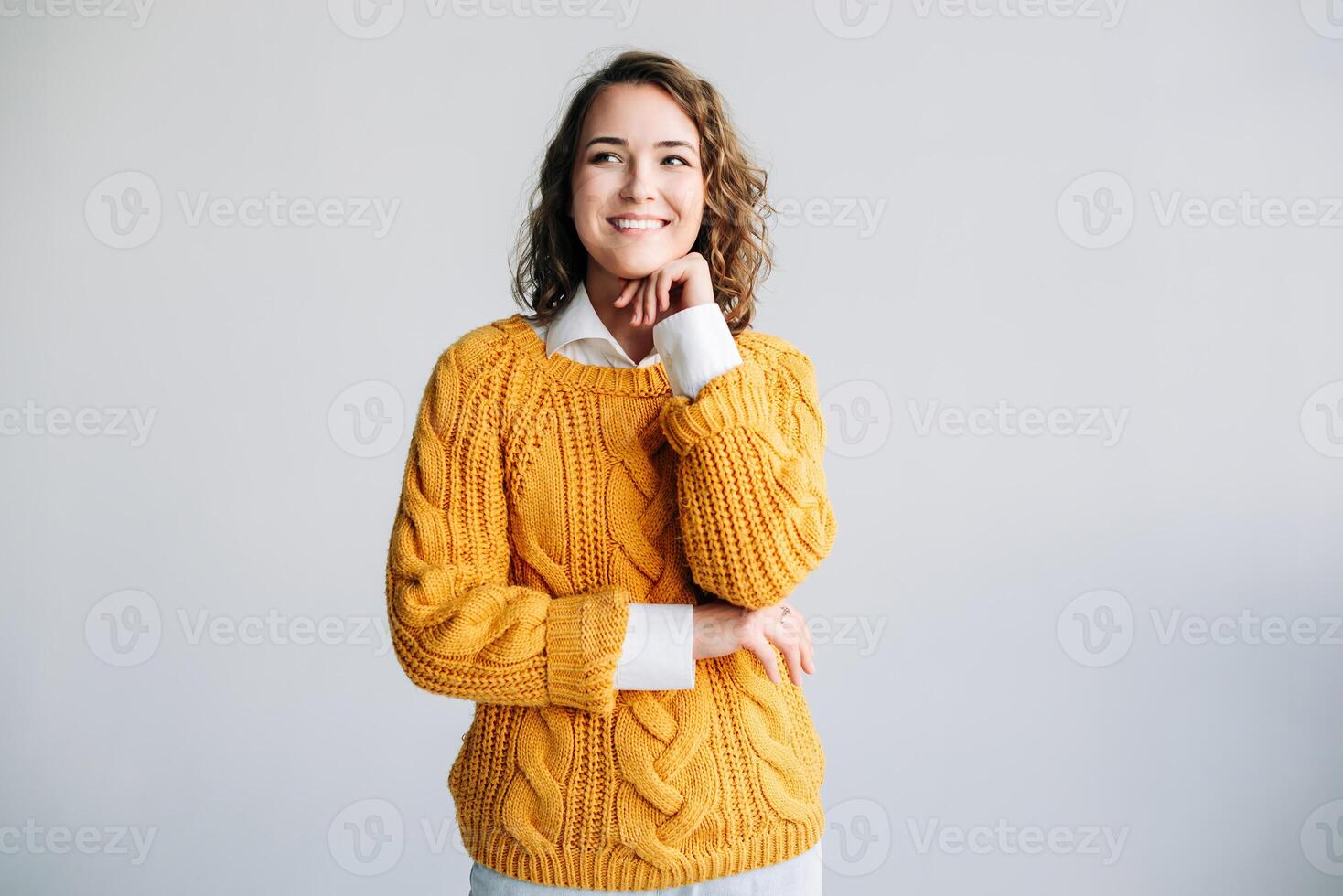 Young Woman Student Contemplates Future - Dreamy, Smiling, Hand on Chin - Reflecting on Ideas and Opportunities - Isolated on White Background - Conceptual Image of Hope and Aspiration for Success. photo