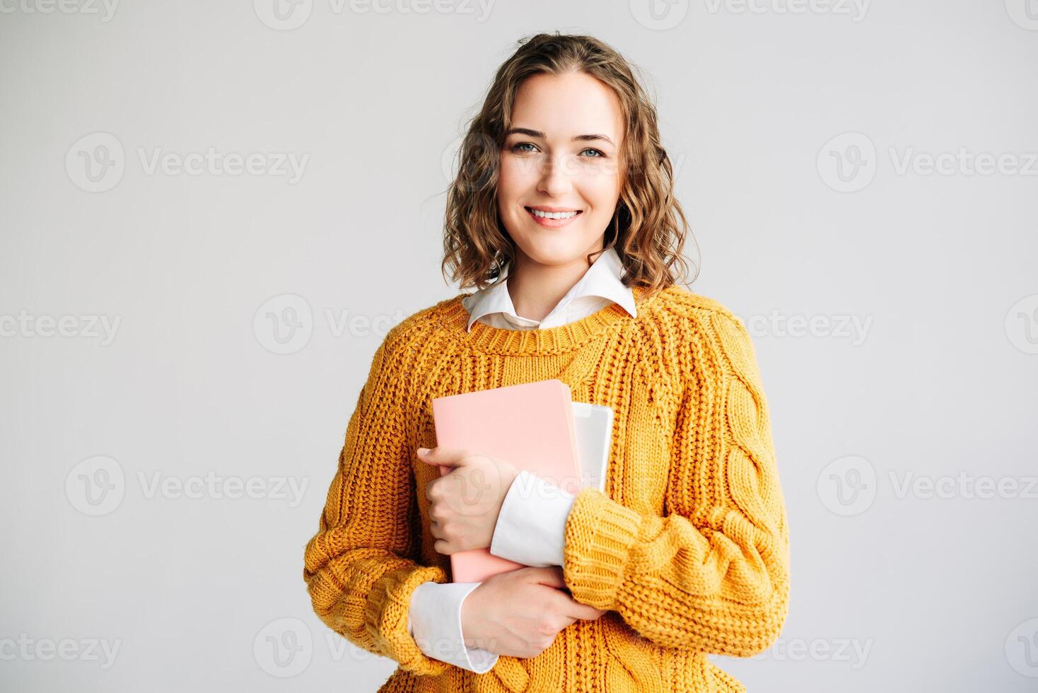 Smiling Woman Holding Digital Tablet. Happy young woman holding a digital tablet, standing against a white background. Perfect for online education, e-learning courses, digital technology photo