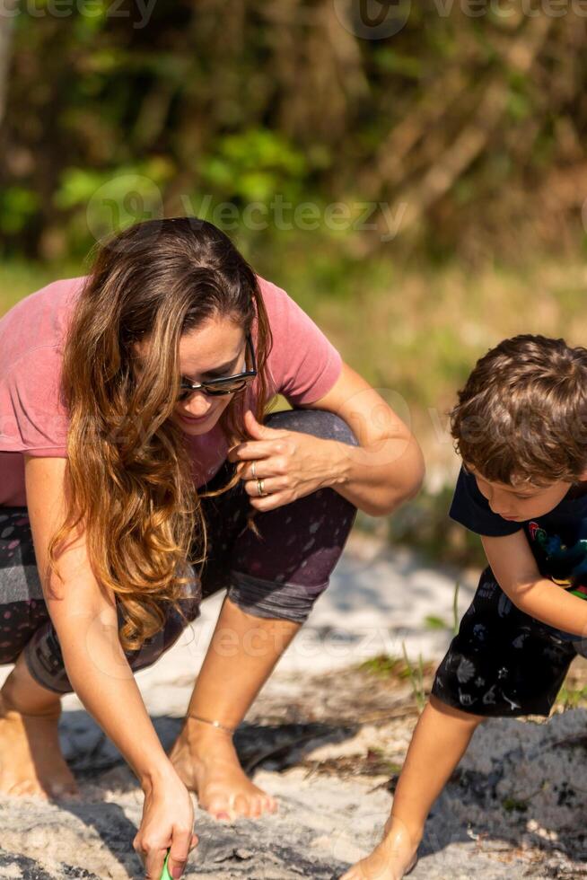 Young caucasian family having a picnic at the lake on a sunny afternoon. photo