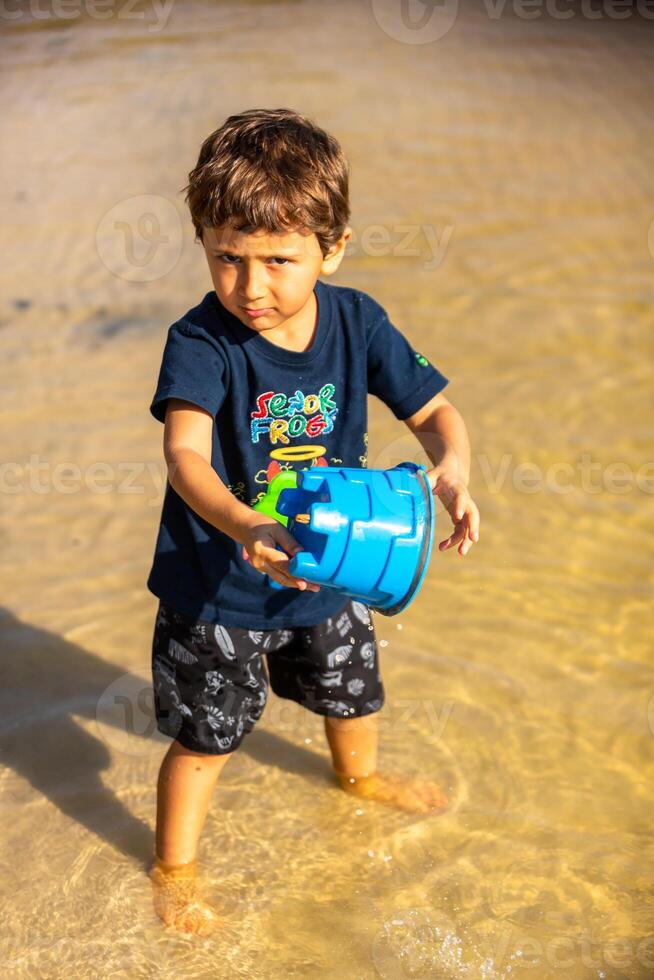 Young caucasian family having a picnic at the lake on a sunny afternoon. photo