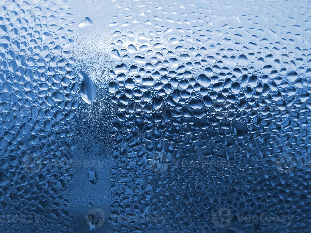 Natural water drops on glass photo