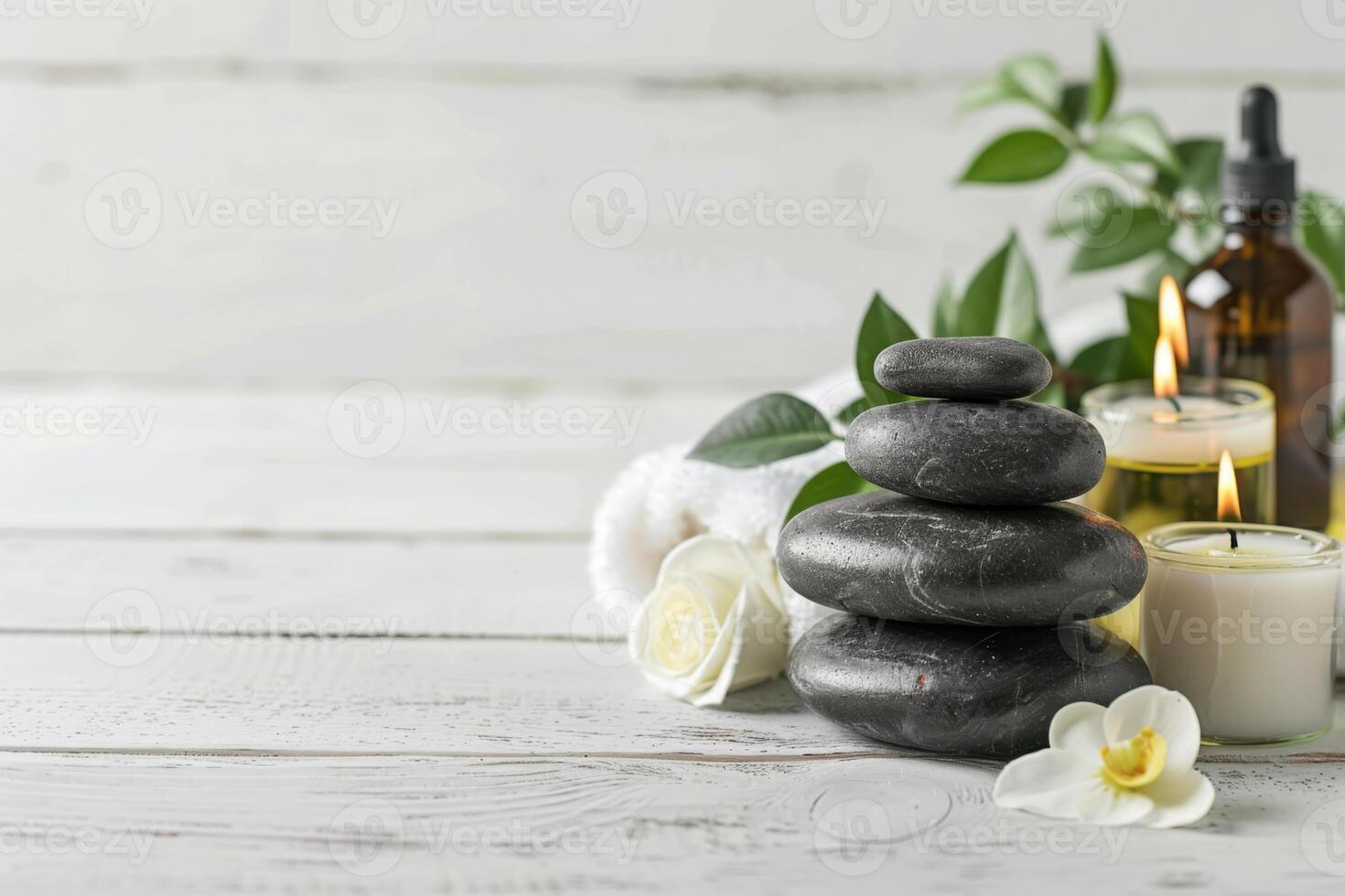 Massage stones, essential oils and candle on a white wooden table. Beauty items for spa procedure. photo