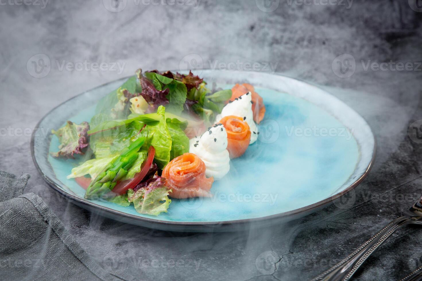 salad of leaves of different types of lettuce and fish rolls, top view photo