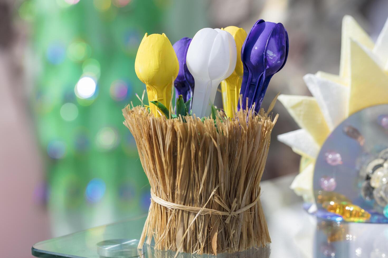Belarus, the city of Gomel, September 14, 2019. Ecological holiday.Ecological decoration from garbage. Flowers from plastic spoons in a straw glass. Handmade craft photo