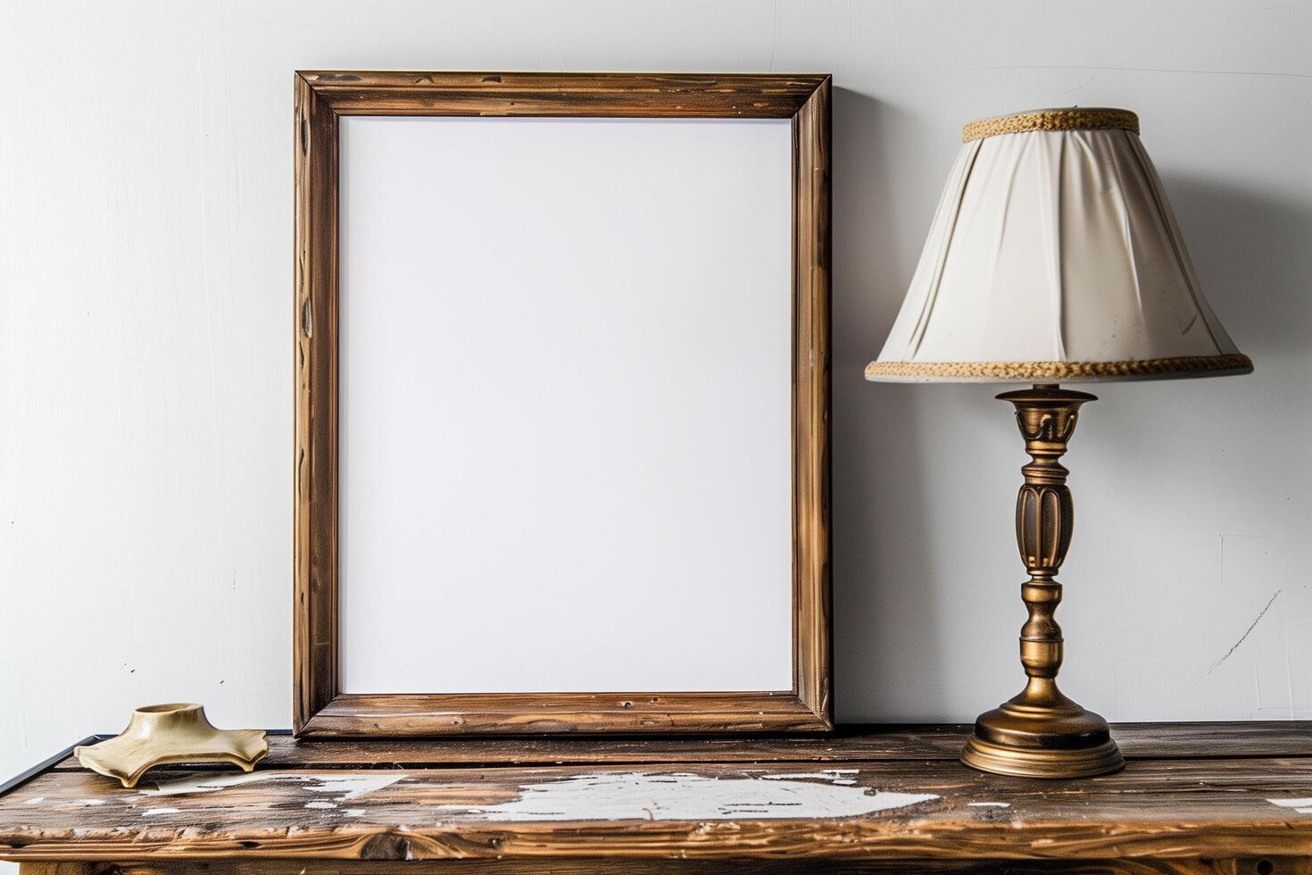 a wooden table with a blank white canvas with wood frame and a lamp photo