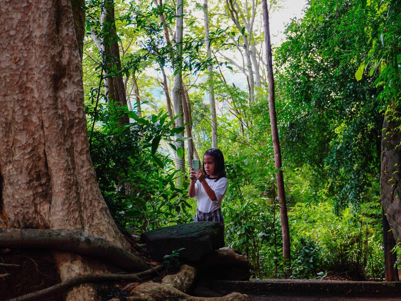 Tourist girls walk on wooden bridges at Phu Thok or Wat Chetiyakhiri ,Beautiful mountain landscape, Bueng Kan Province, Thailand. photo