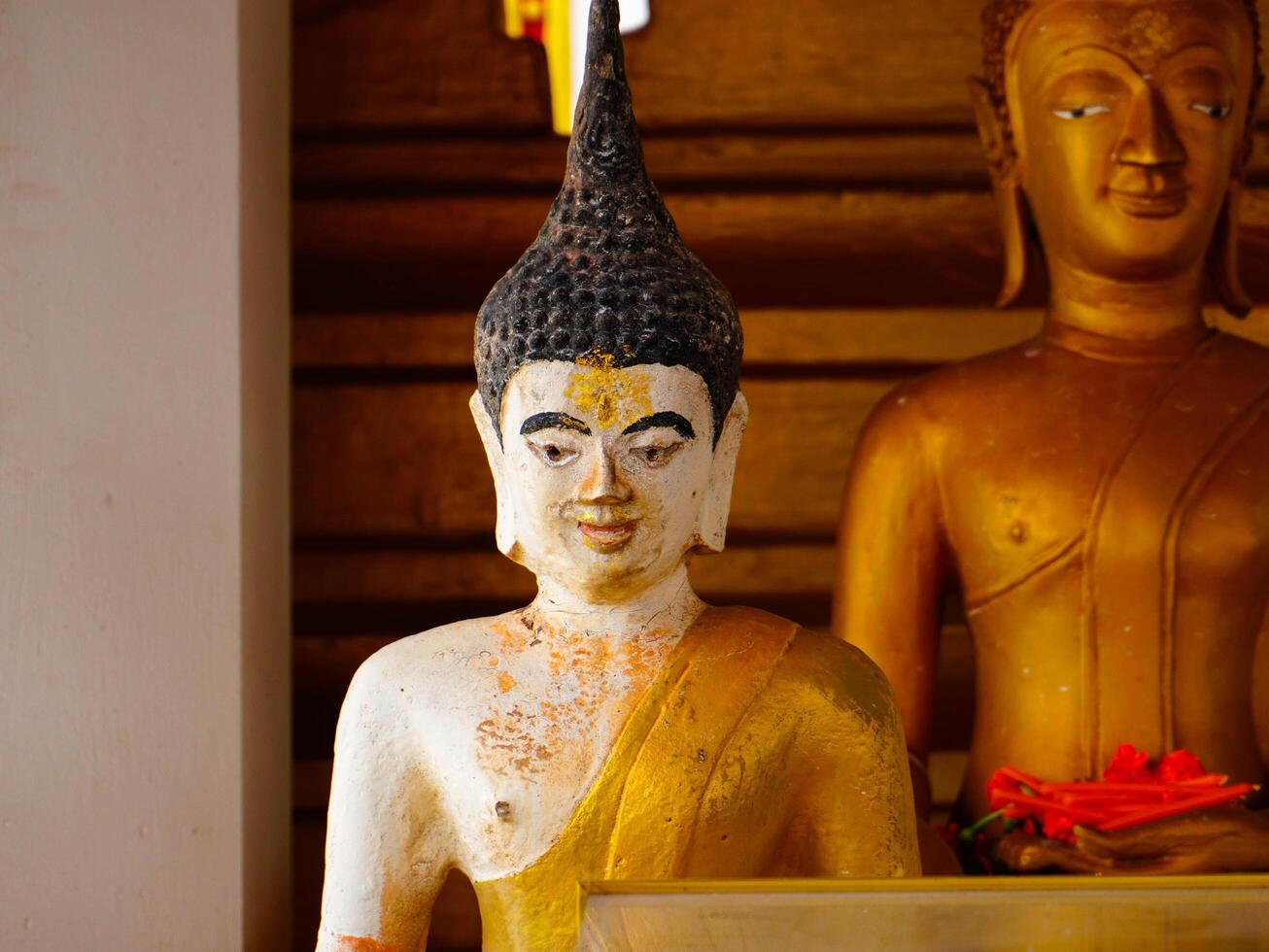 Buddha statues and sculptures at Phra That Luang or Phra Chedi Lokachulamanee is considered a very important place of worship in Vientiane, Laos. photo
