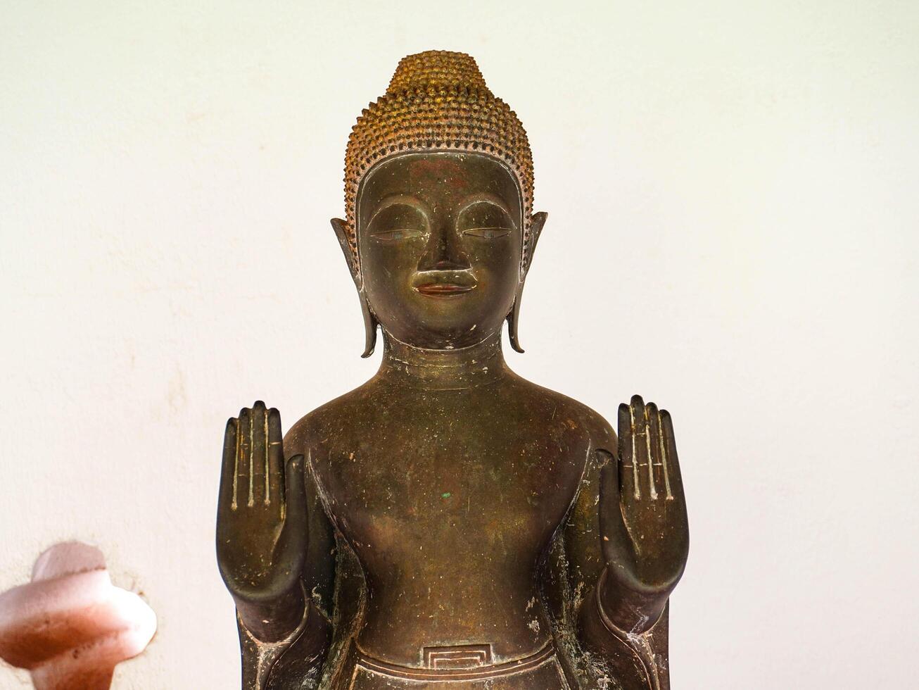 Buddha statues and sculptures at Phra That Luang or Phra Chedi Lokachulamanee is considered a very important place of worship in Vientiane, Laos. photo