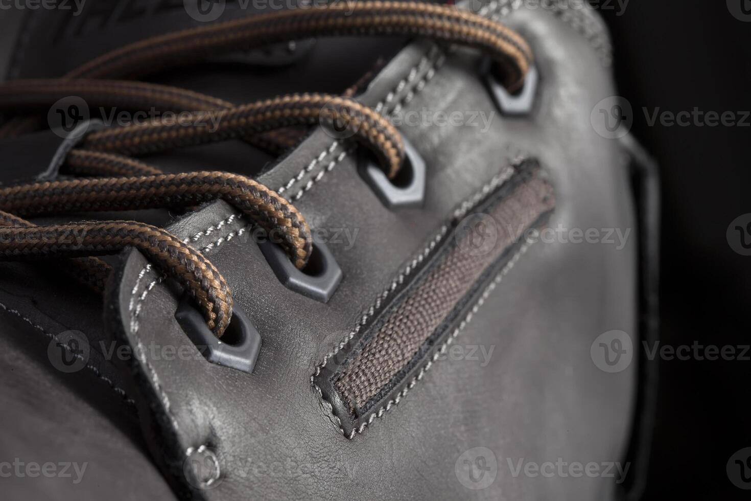 Part of a leather boot close-up. A fragment of the texture of leather shoes. photo