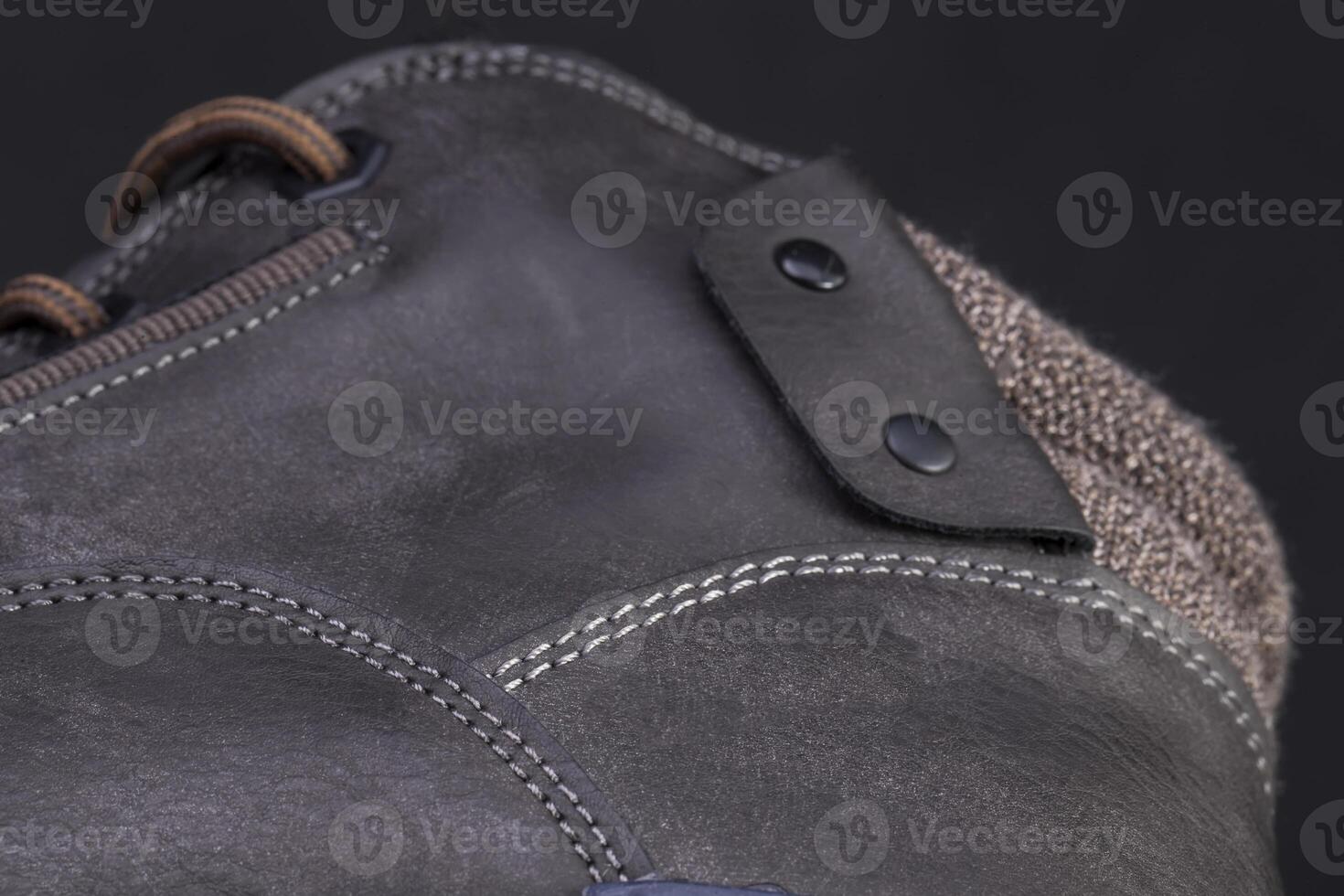 Part of a leather boot close-up. A fragment of the texture of leather shoes. photo