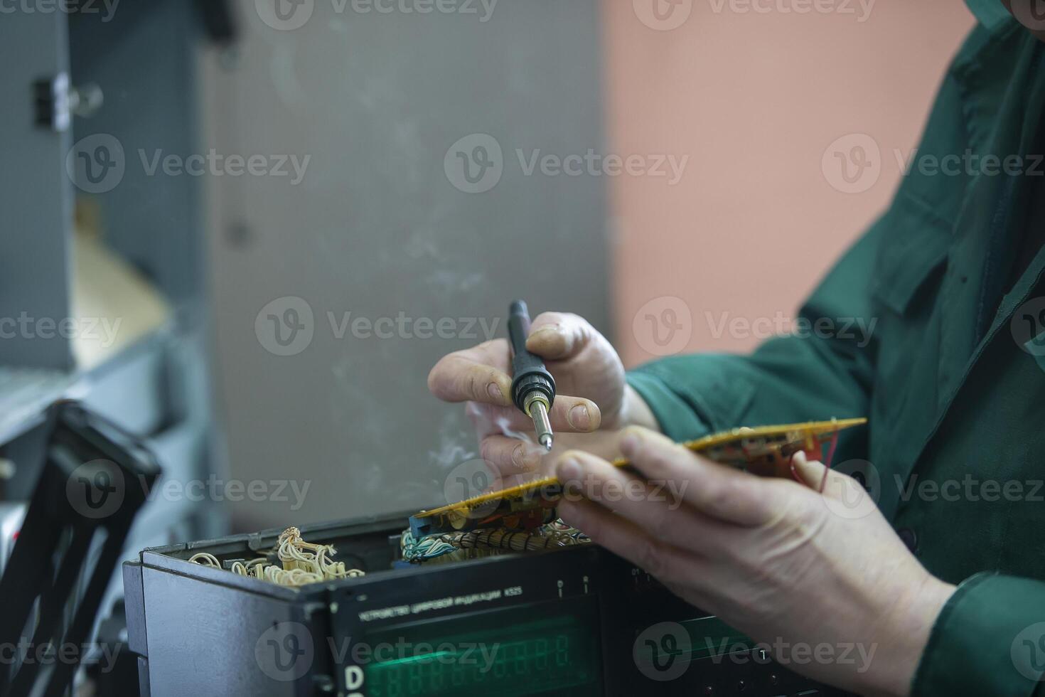 Hands solder a soldering iron board photo