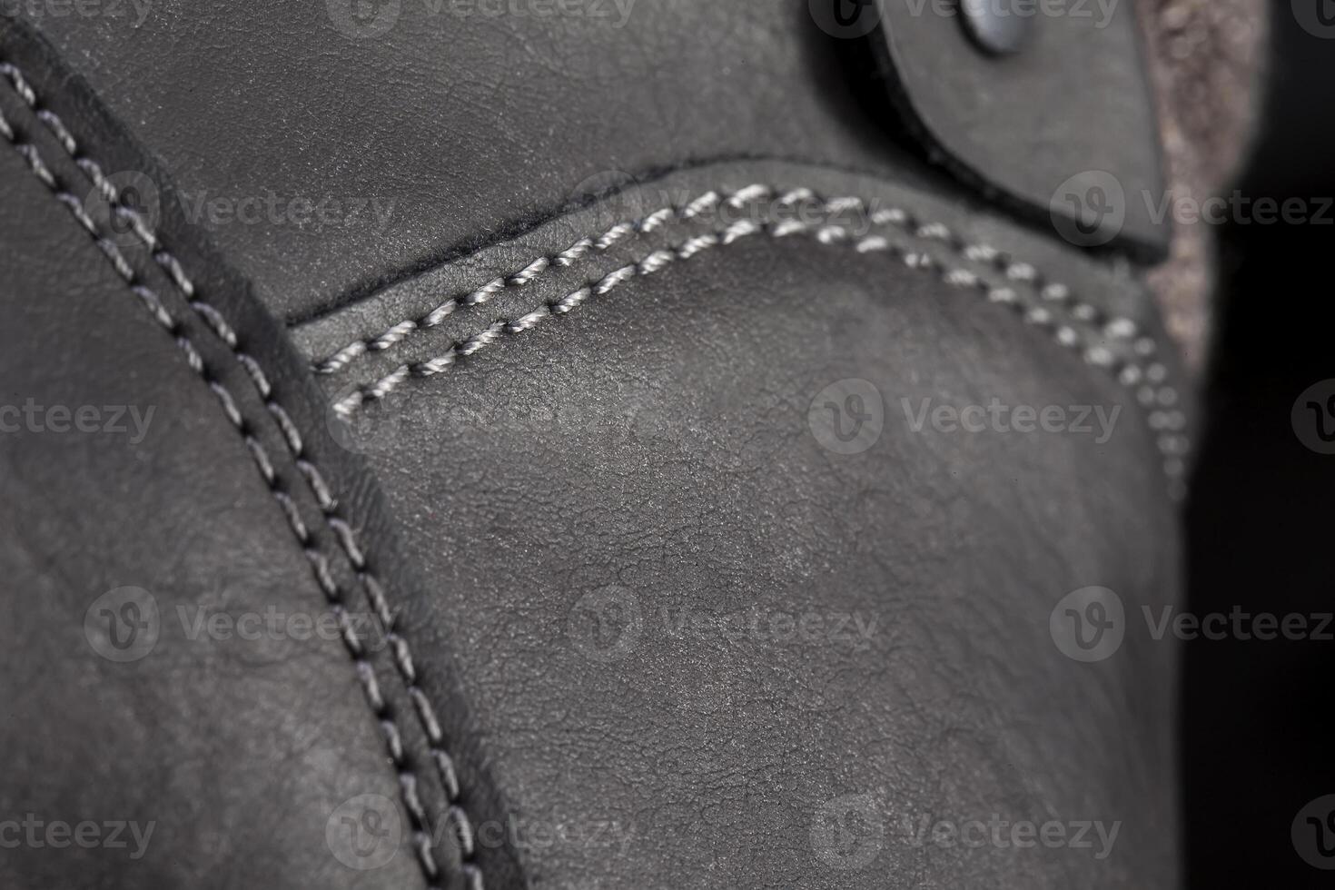 Part of a leather boot close-up. A fragment of the texture of leather shoes. photo