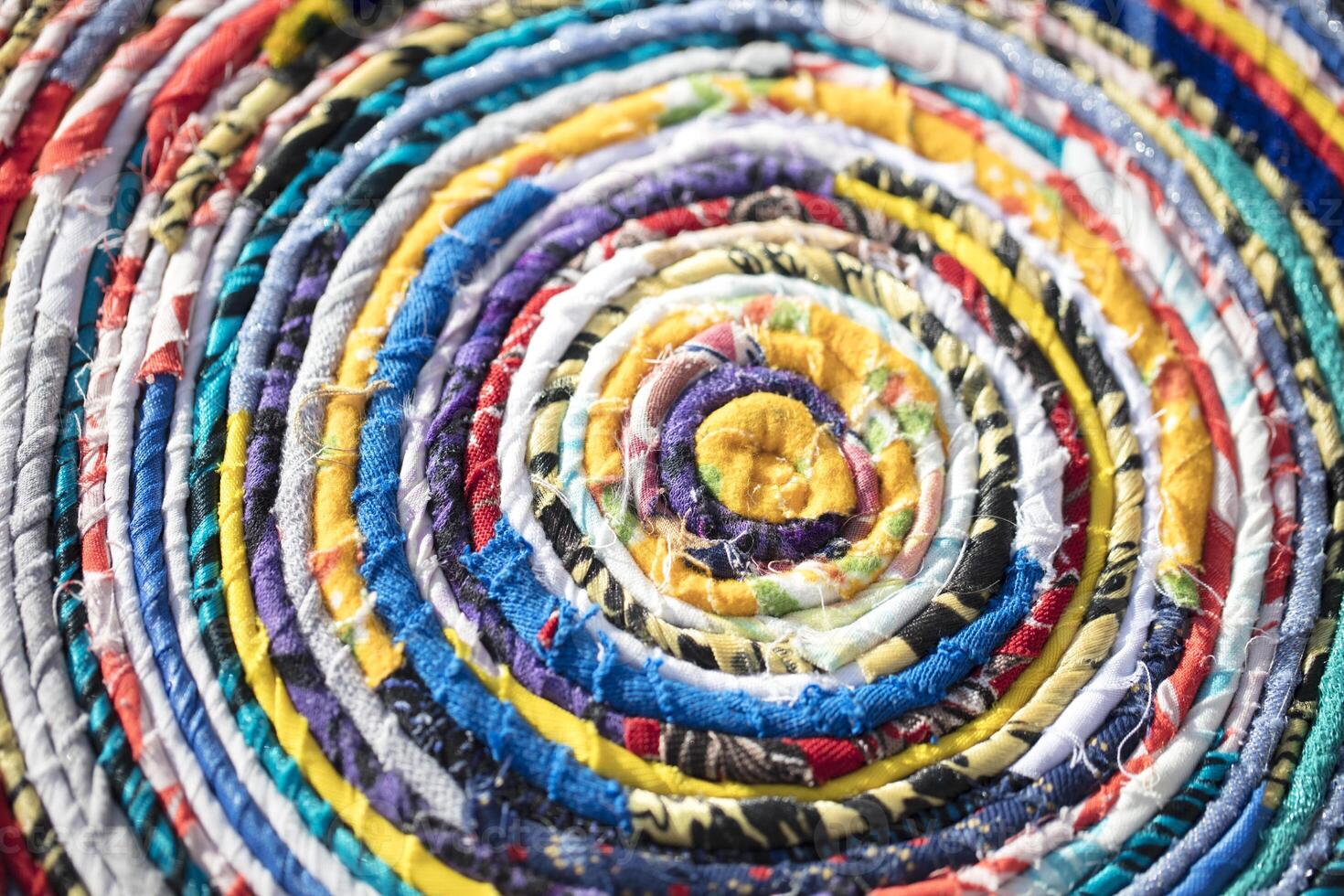 Background roll of twisted fabric close-up. Many rags of different colors photo