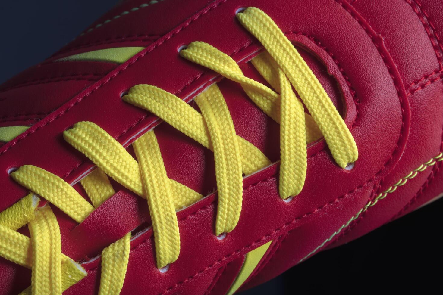The texture of a red sneaker closeup. Part of leather sports shoes photo