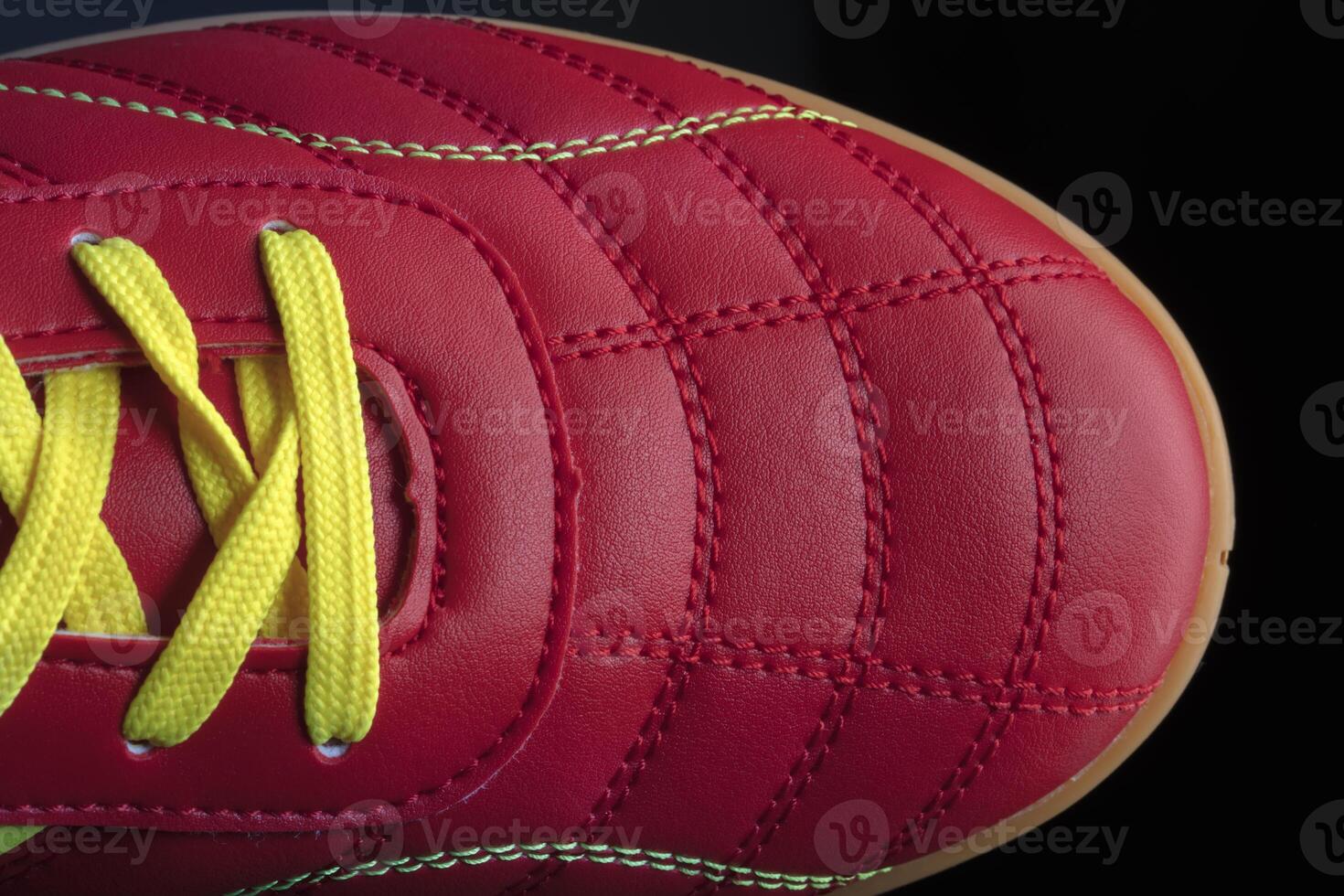 The texture of a red sneaker closeup. Part of leather sports shoes photo