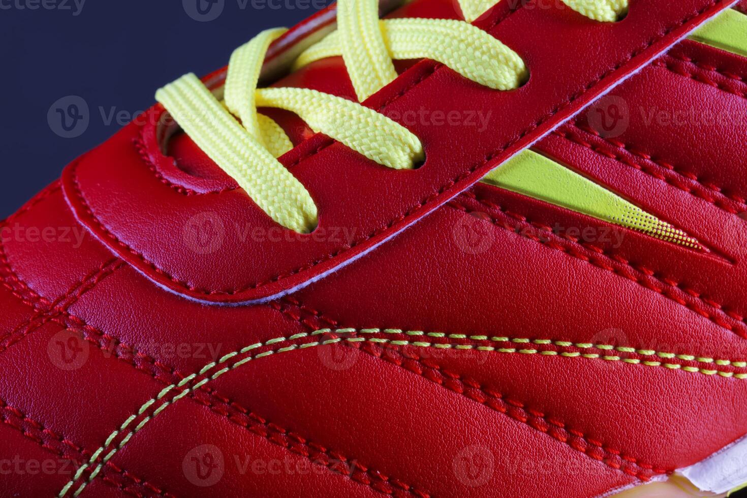 The texture of a red sneaker closeup. Part of leather sports shoes photo