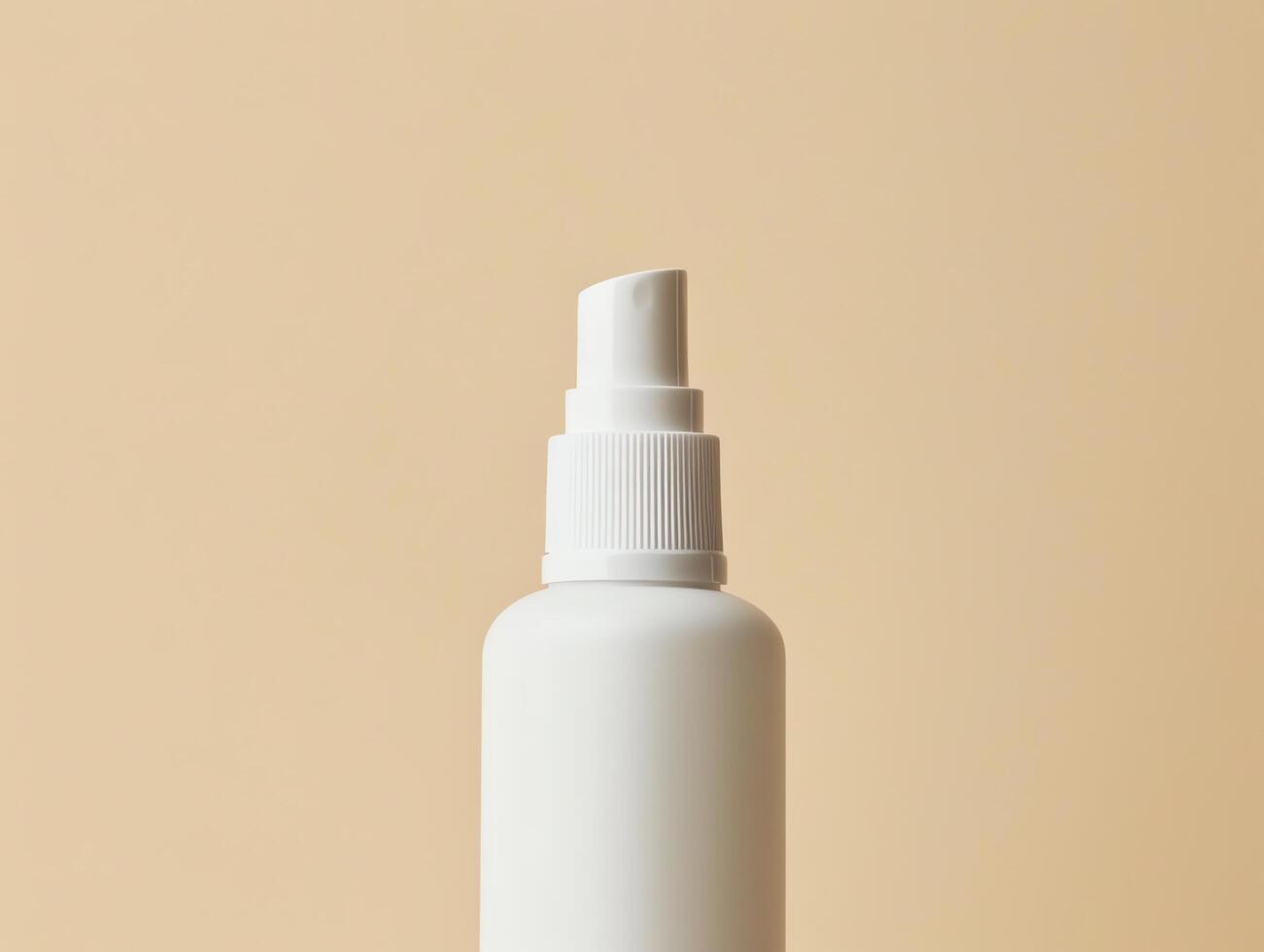 White plastic spray bottle with a fine mist nozzle on a beige background. photo