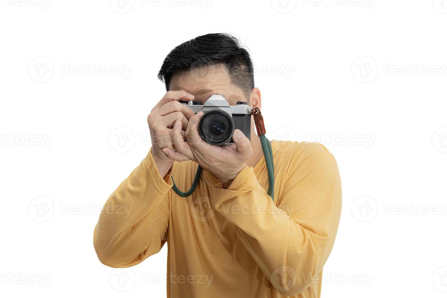 Handsome young man holding DSLR camera on white. Professional male photographer with digital camera shooting in white isolated photo studio.