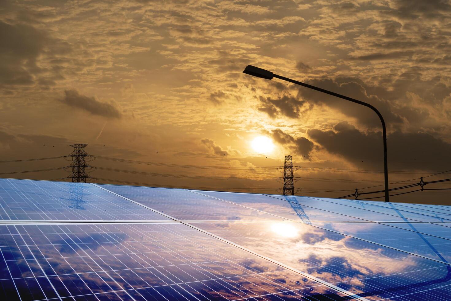 Photovoltaic solar panels mounted on building roof for producing clean ecological electricity at sunset. Production of renewable energy concept. photo