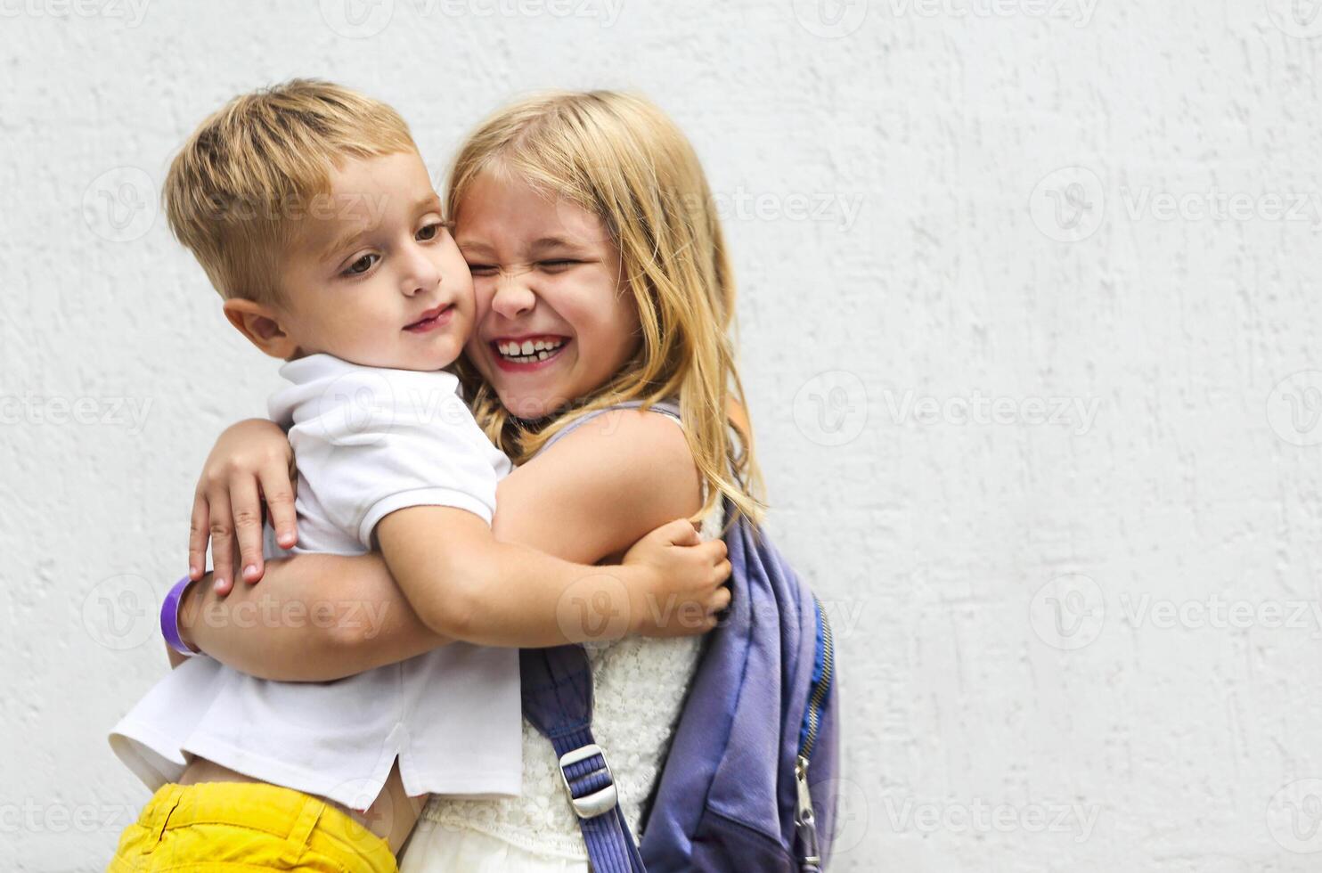 Portrait of adorable brother and sister smile and laugh together outdoors photo