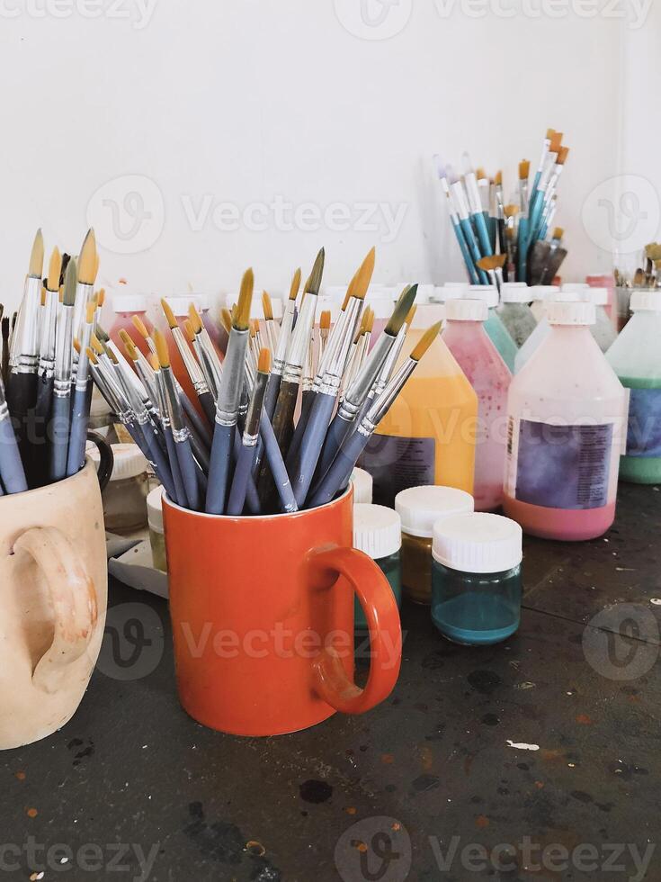 Creative workspace with painting tools on table photo