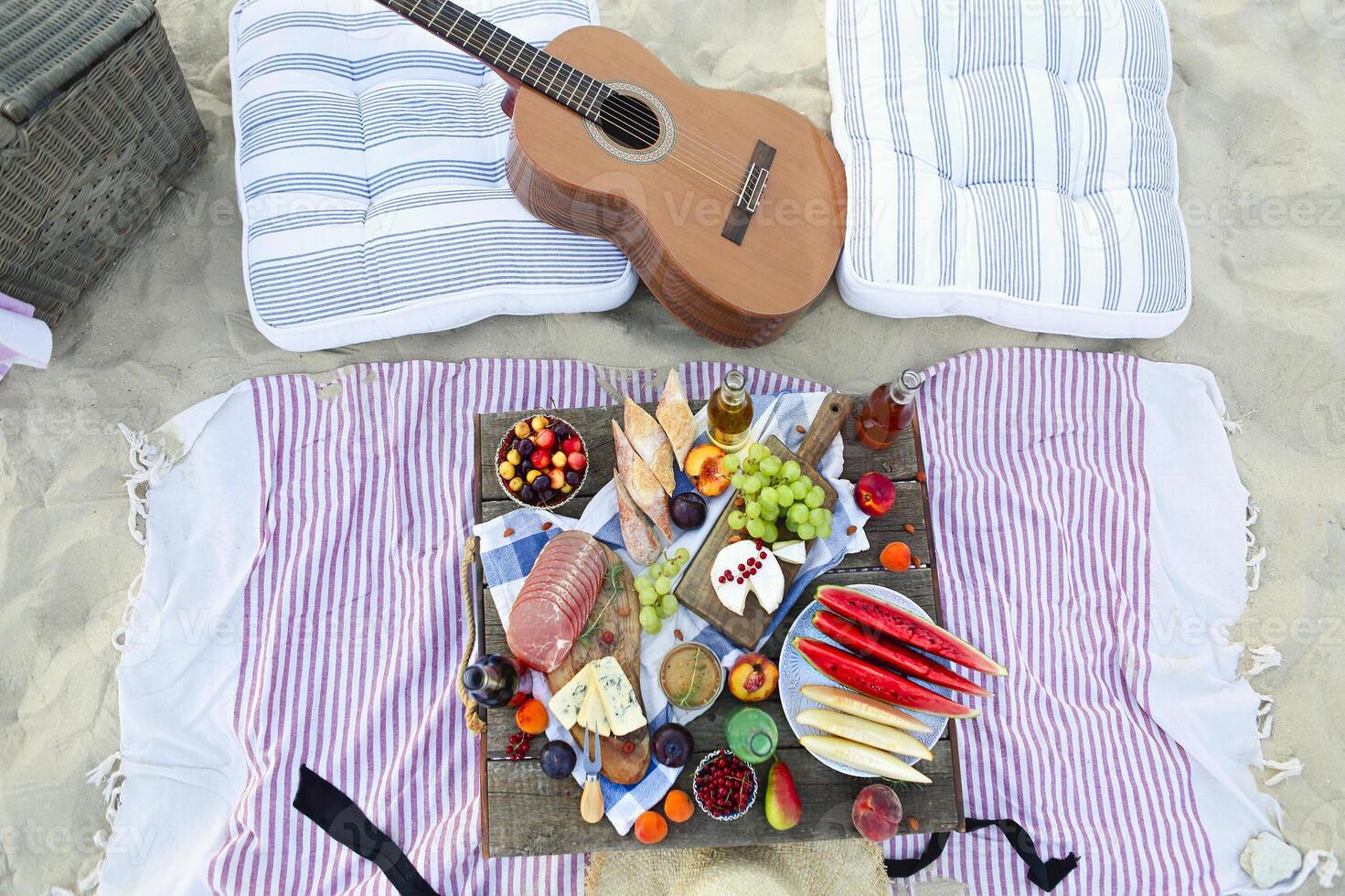 Picnic on the beach at sunset in the style of boho photo