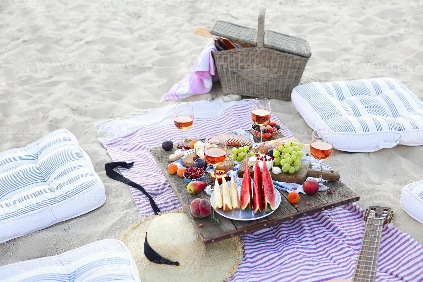 Picnic on the beach at sunset in the style of boho photo
