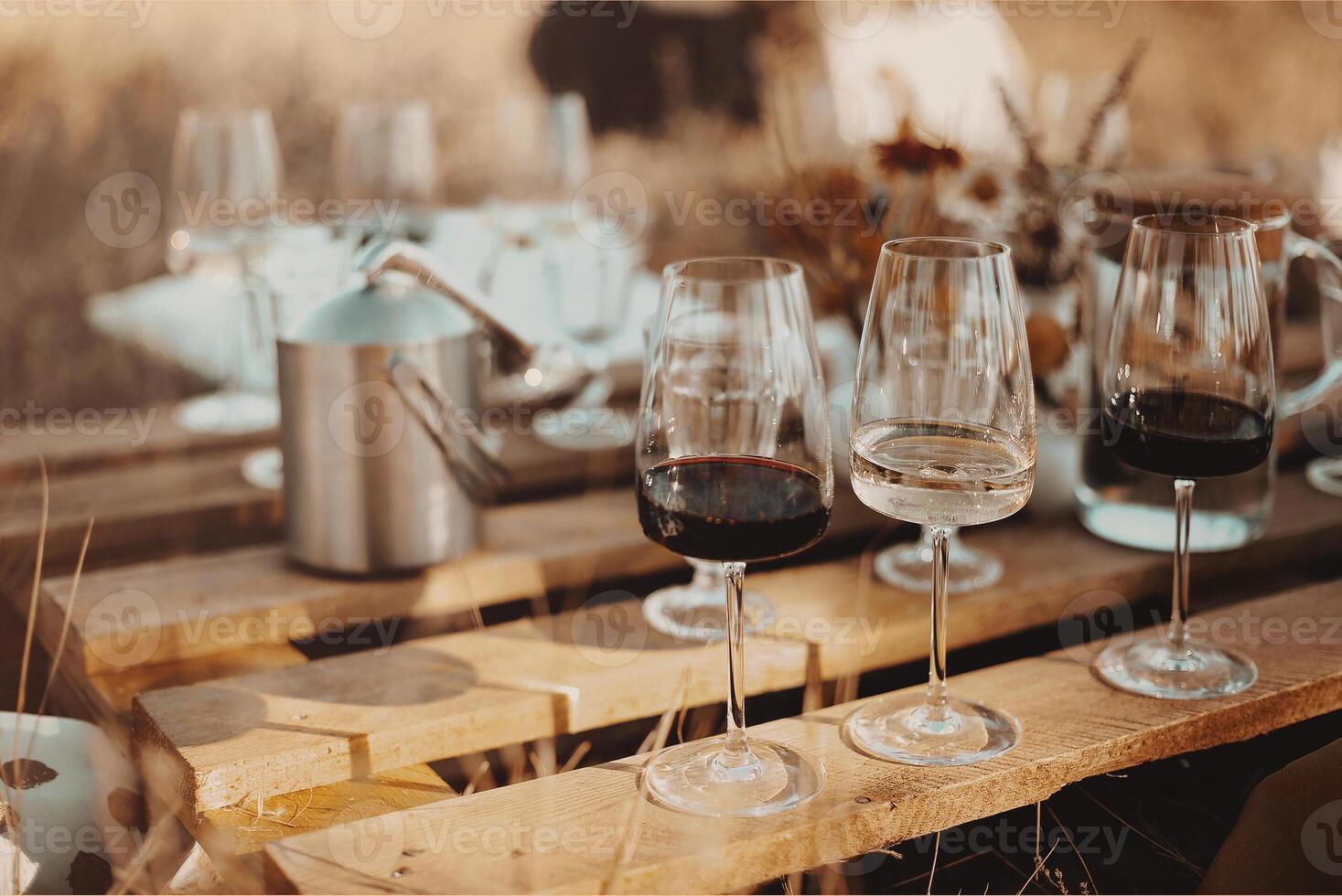 Wooden table with glassware arranged for picnic photo