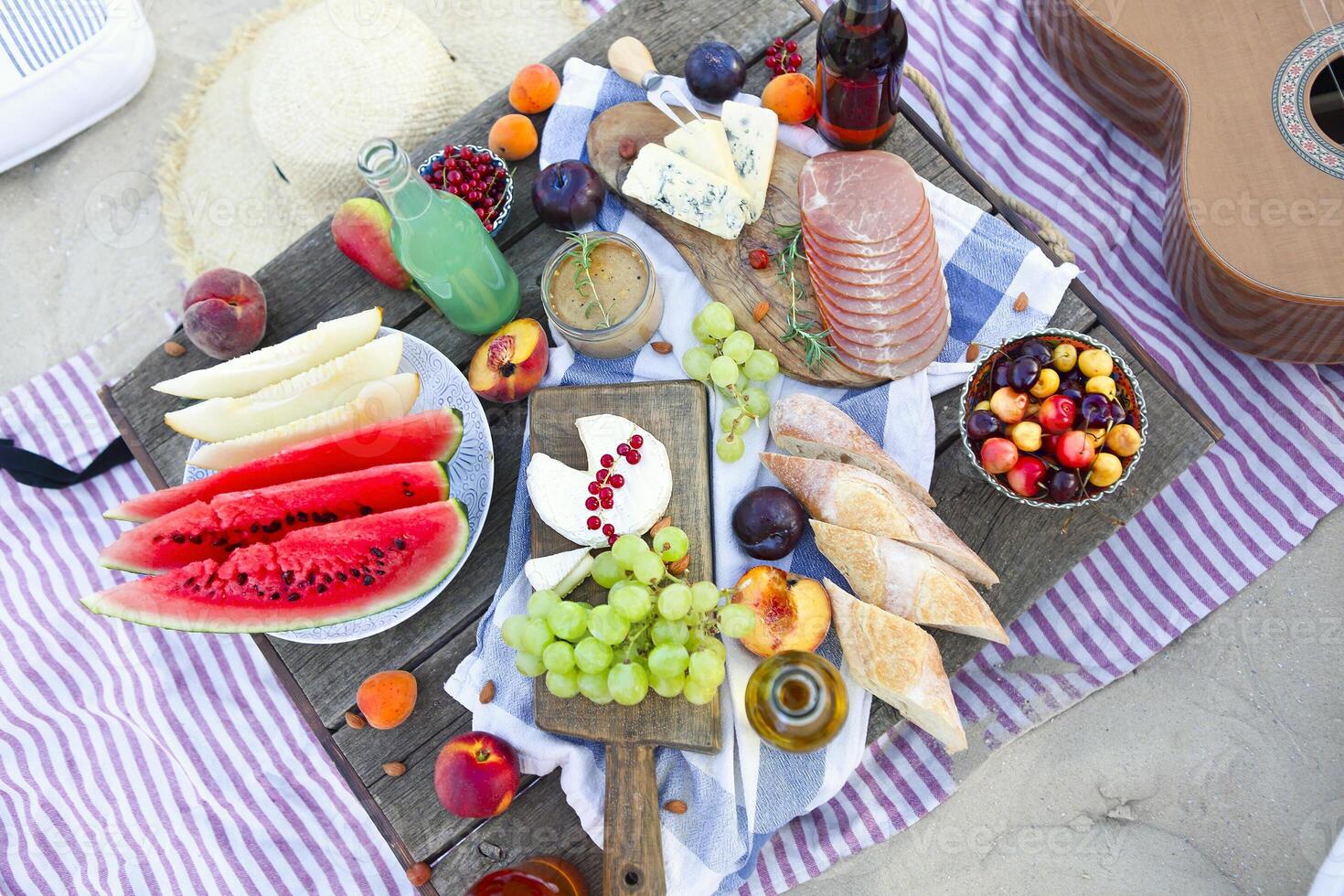 Picnic on the beach at sunset in the style of boho photo