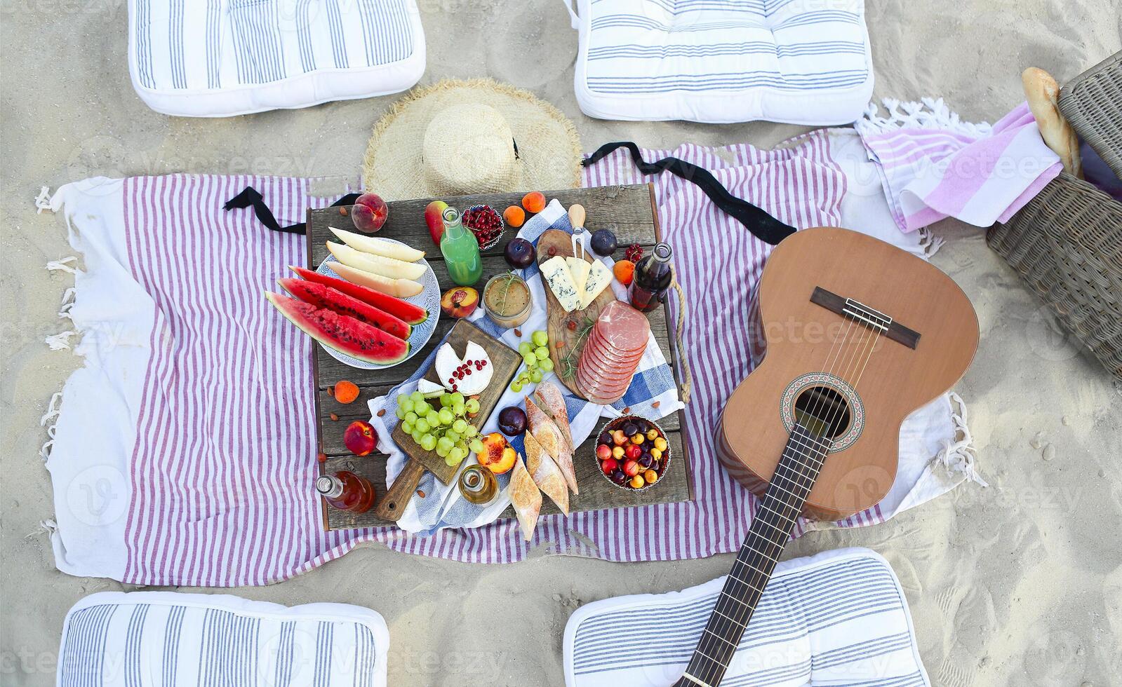 Picnic on the beach at sunset in the style of boho photo