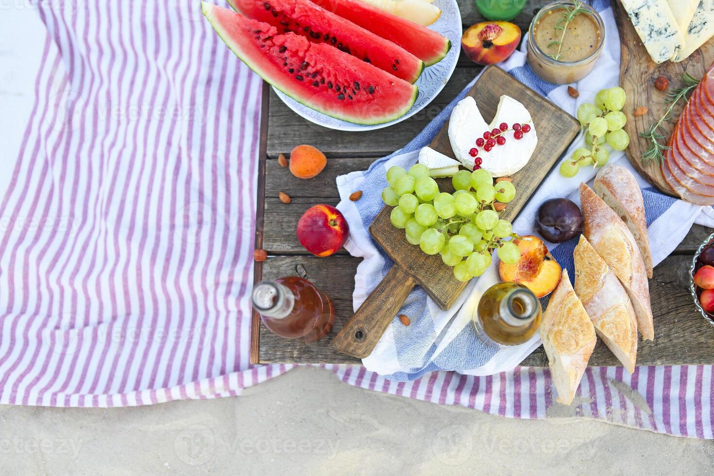 Picnic on the beach at sunset in the style of boho photo
