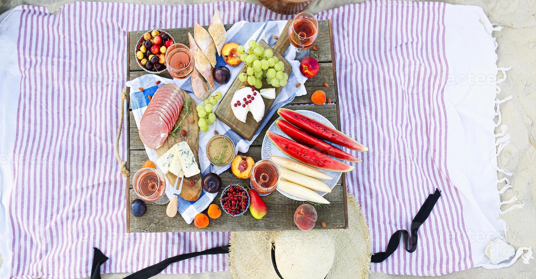 Picnic on the beach at sunset in the style of boho photo