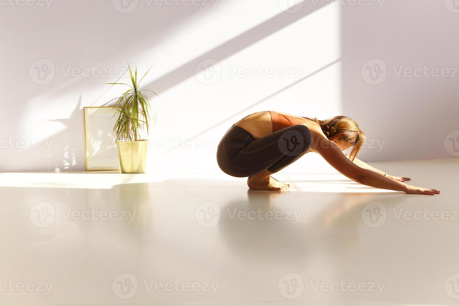 Flexible woman doing yoga at home photo