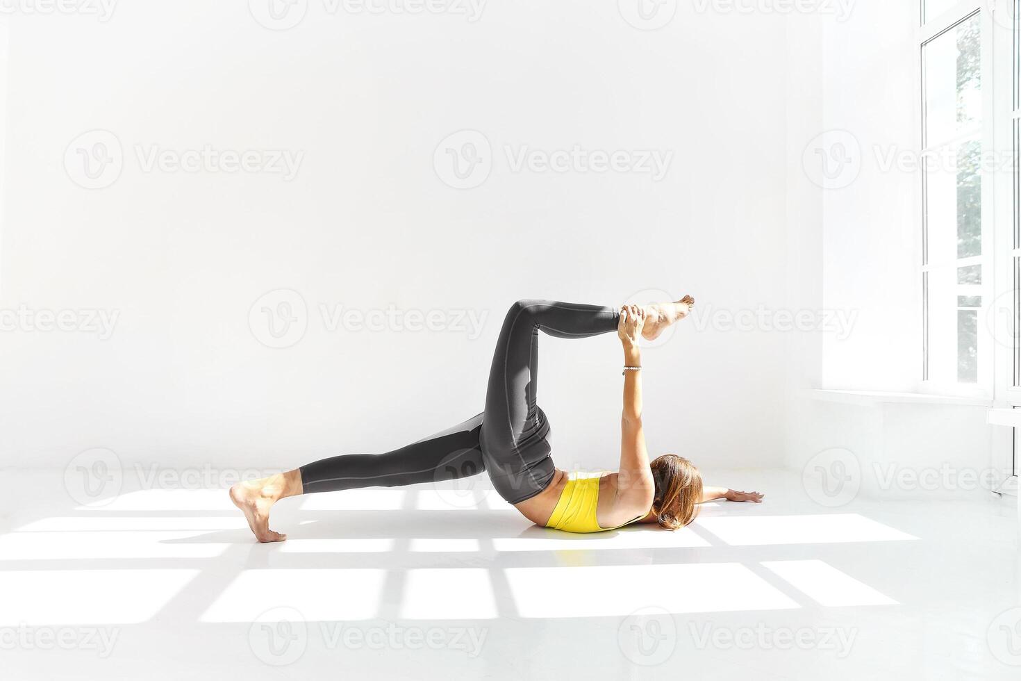 Flexible woman doing yoga at home photo