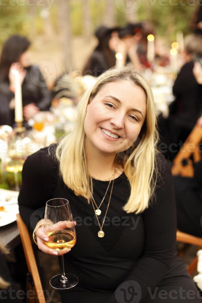 Woman with wineglasses during banquet photo
