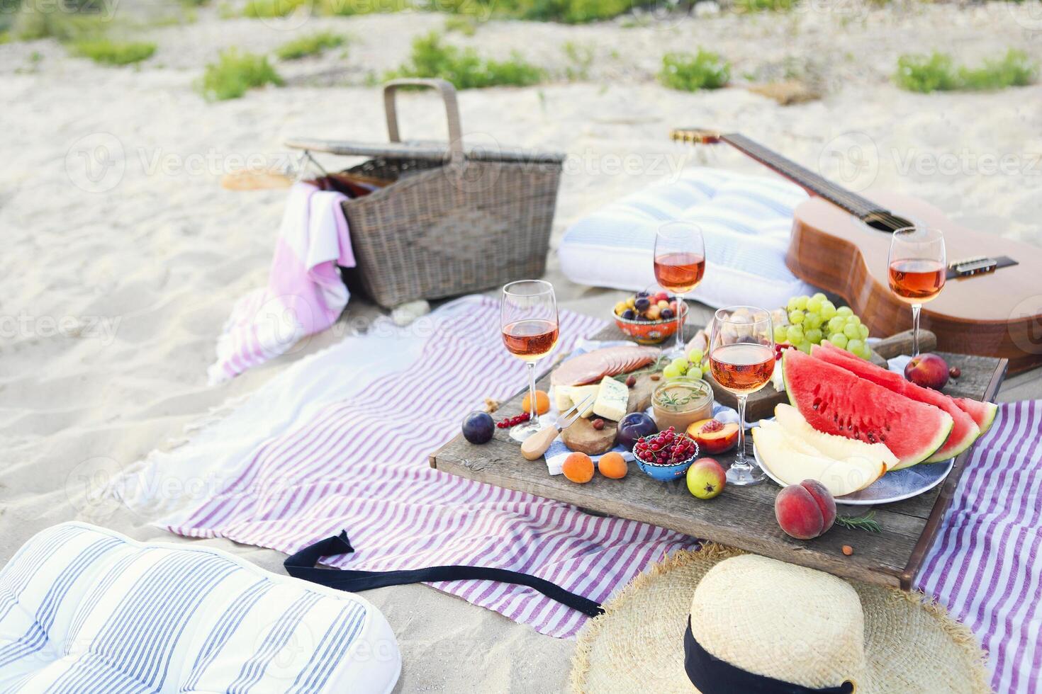 Picnic on the beach at sunset in the style of boho photo