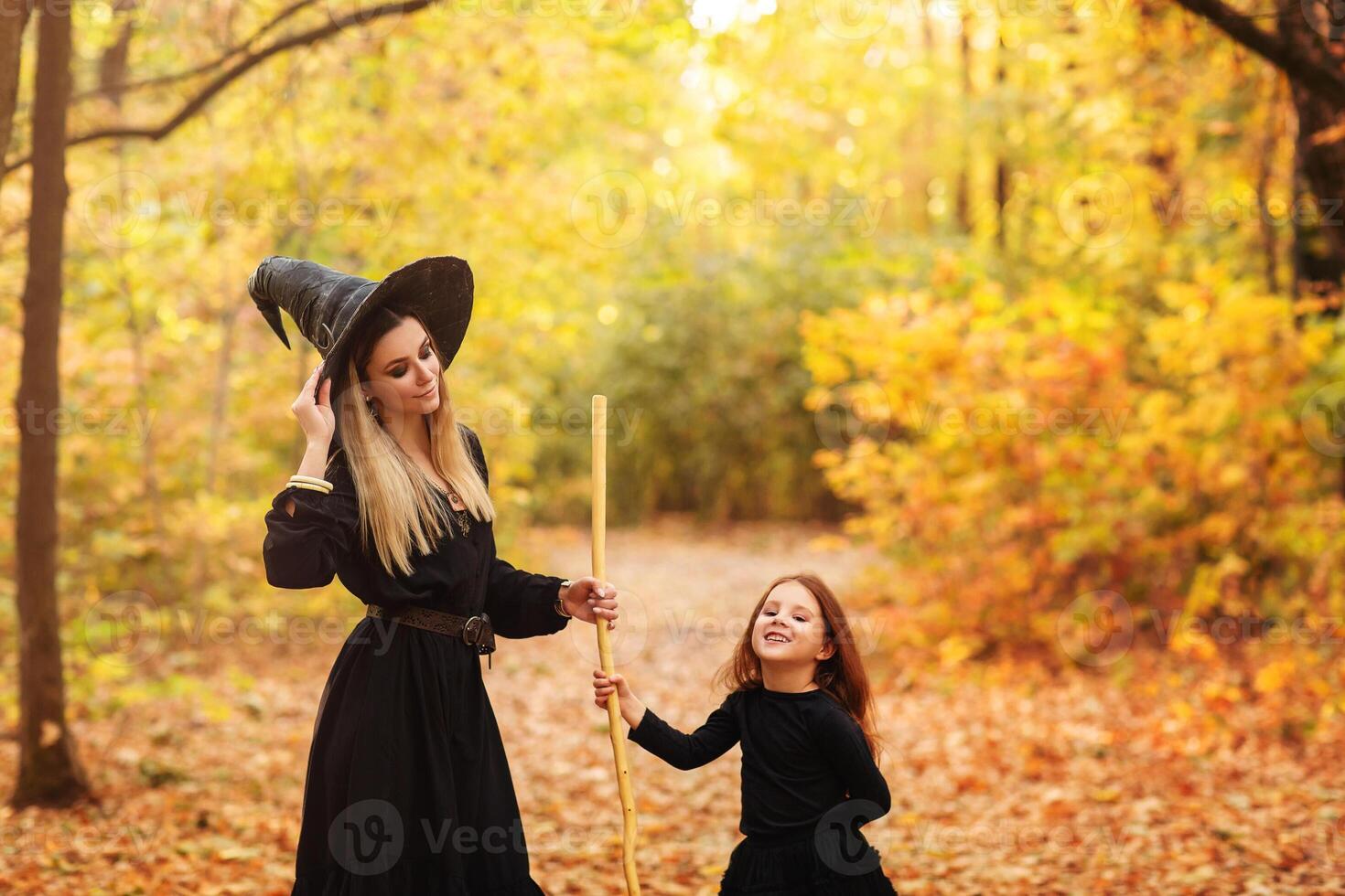 Mother and daughter sweeping path on Halloween day photo