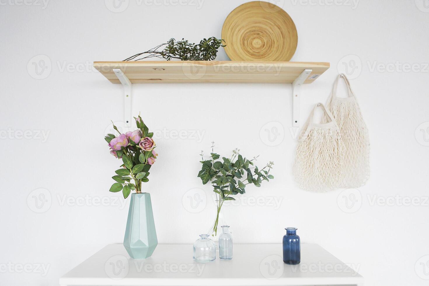 Wooden shelf and white commode on light wall background photo