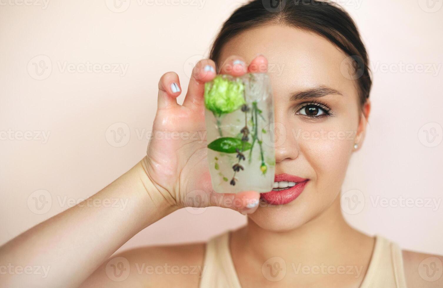 Portrait of the woman with ice cubes for skincare routine photo