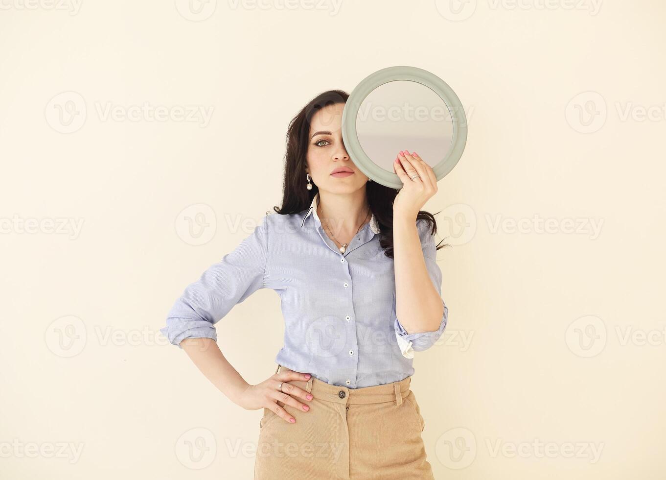 Woman with mirror in studio photo