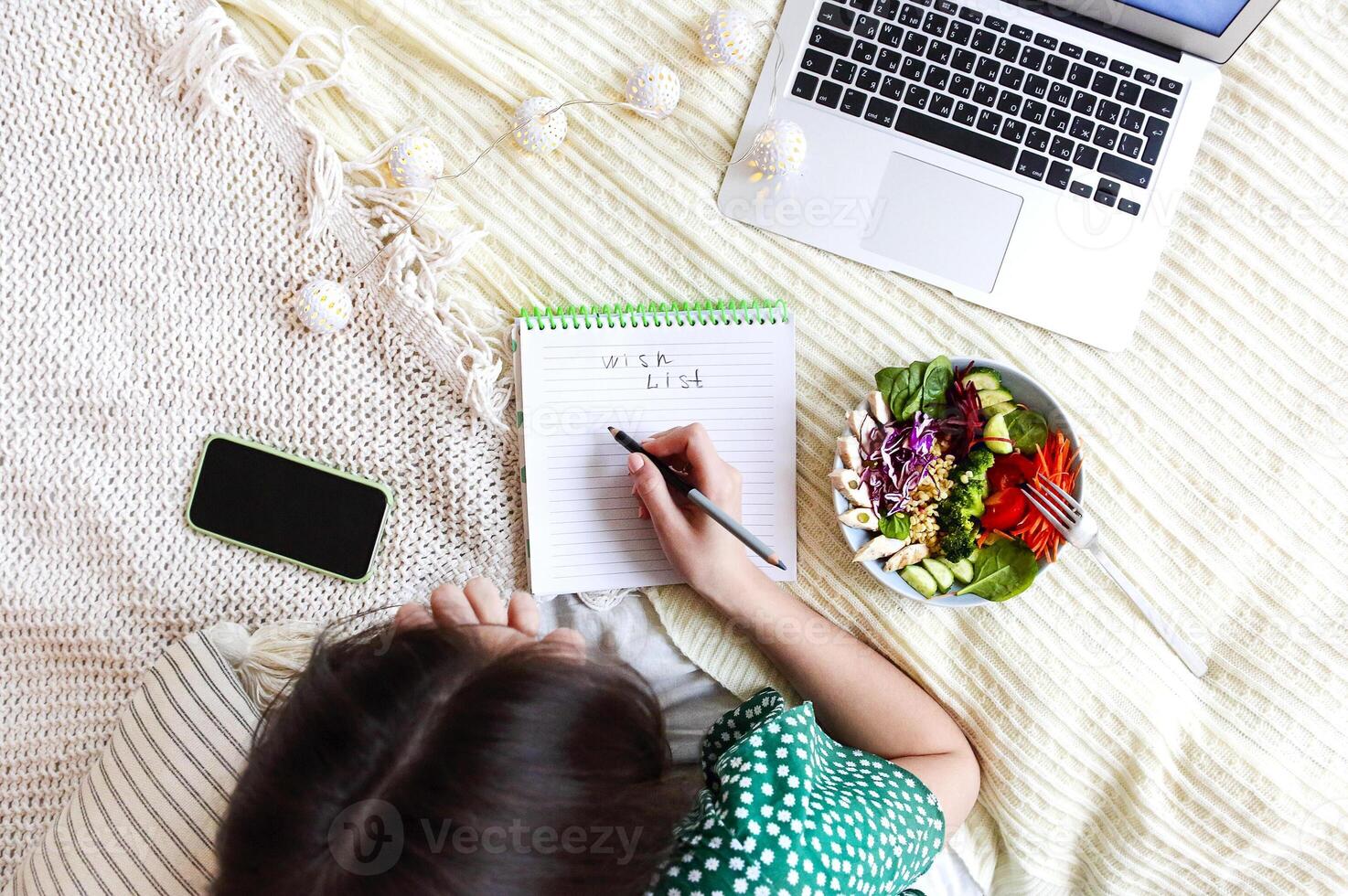Crop woman creating wish list photo