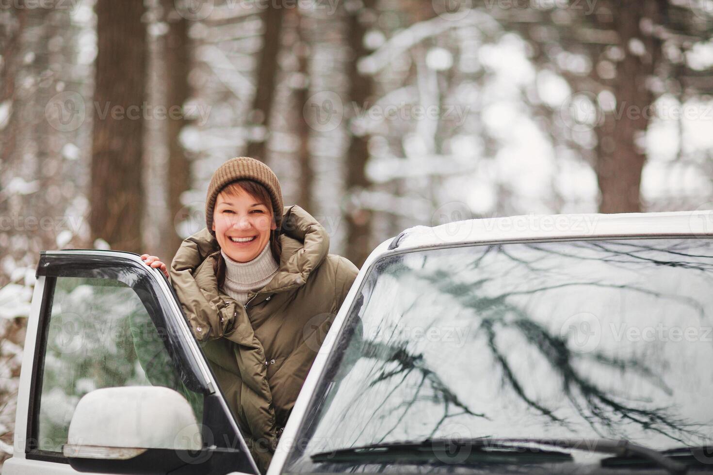 Happy woman driving car in winter photo