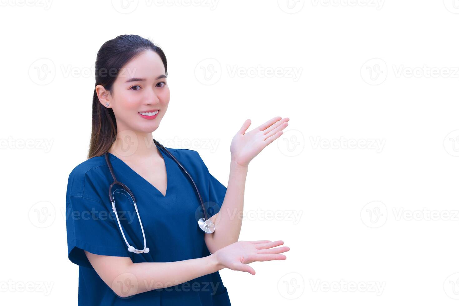 Professional young Asian woman doctor in blue uniform stands and smiles while pointing to the top on while isolated white background. photo