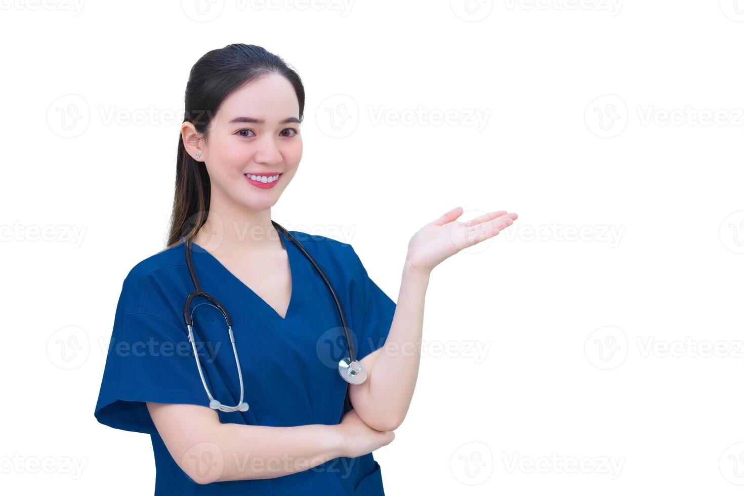Professional young Asian woman doctor in blue uniform stands and smiles while pointing to the top on while isolated white background. photo