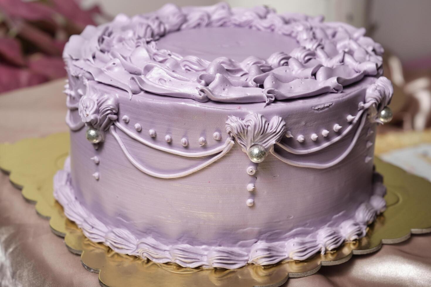 a purple cake with pearls and ruffles on top photo