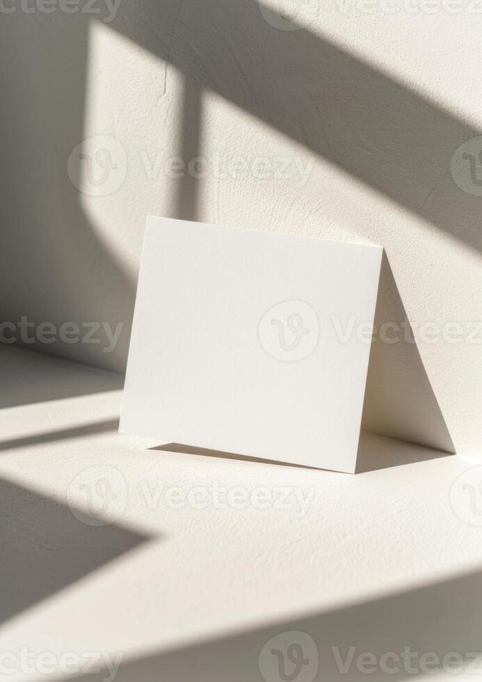 Blank card mockup on a white background with shadow from the window photo