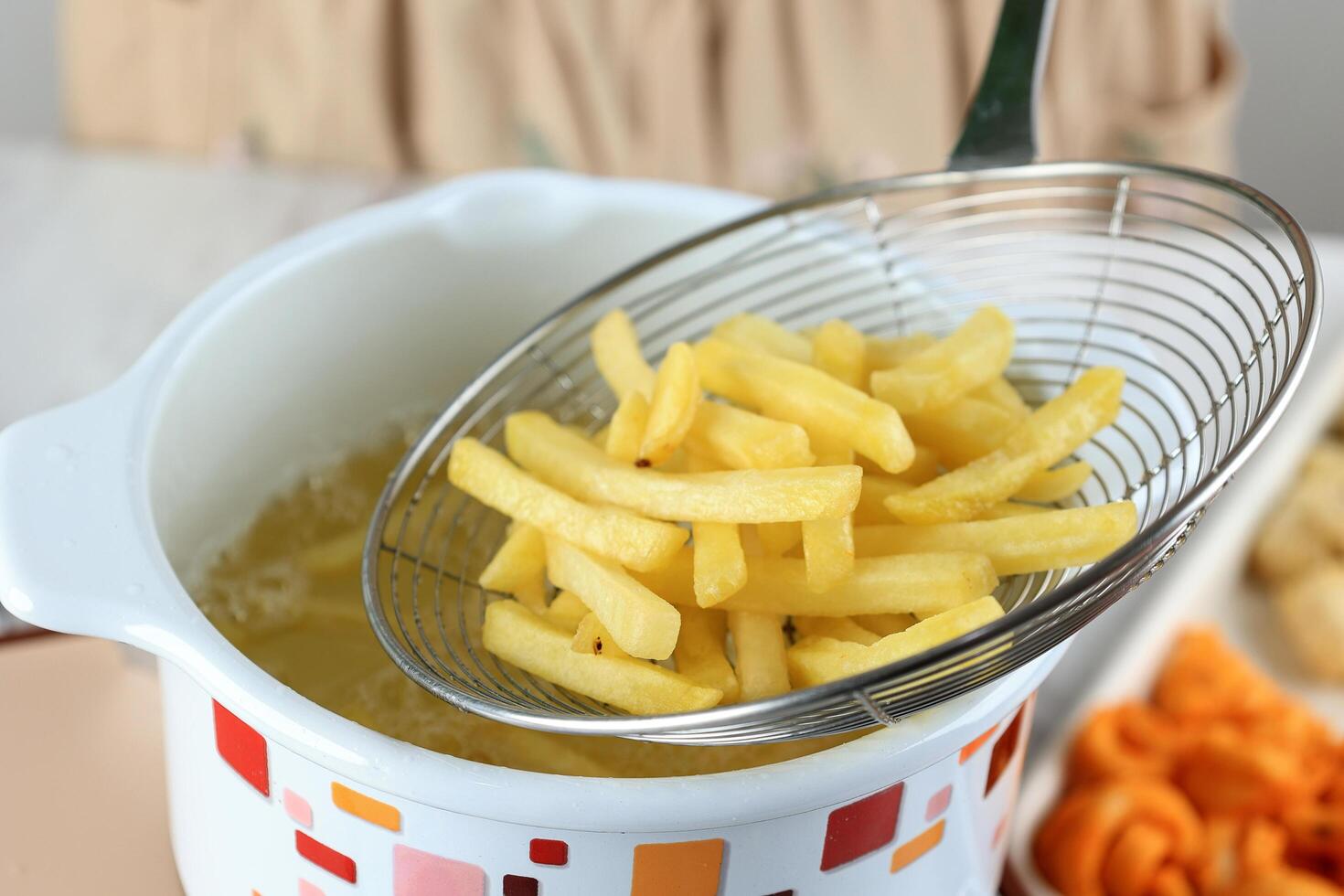 Cooking French Fries at Home, Deep Frying Potato Stick Fast Frozen Food photo